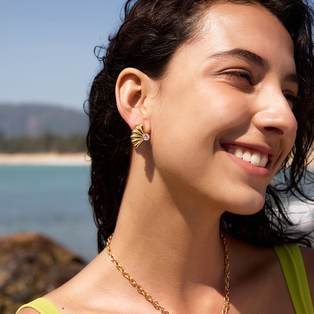 Fluted fan stud earrings shown on a model
