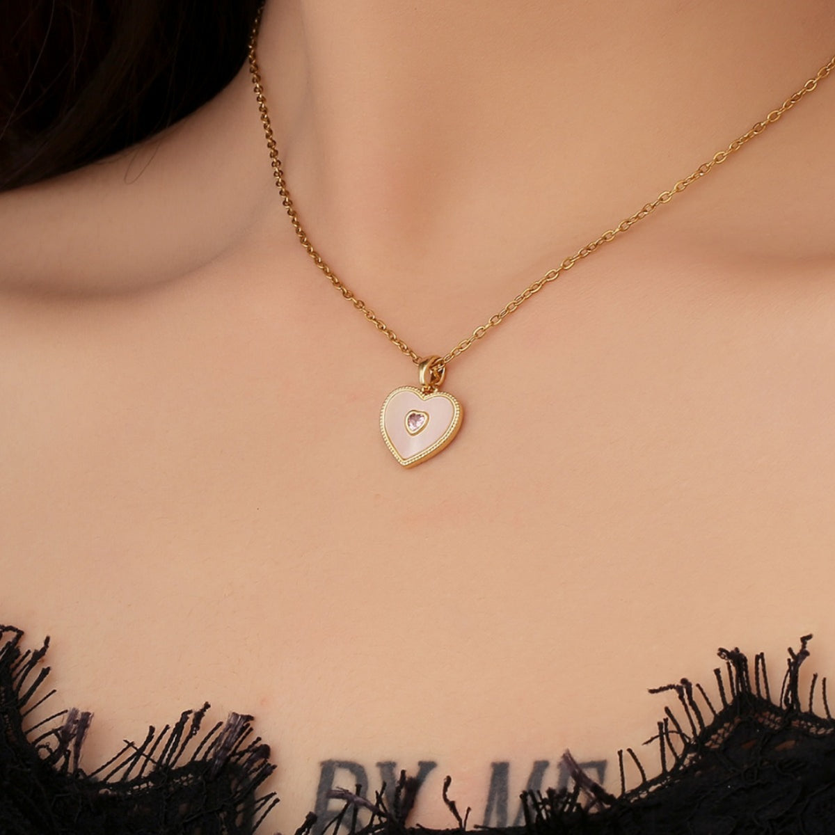 model wearing the small pink-stone heart pendant necklace