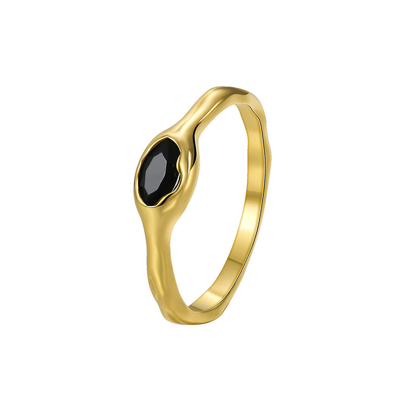 isolated gold plated ring with a single faceted black stone