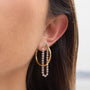 two-tone clear stone chain tassel hoop earrings worn on ear