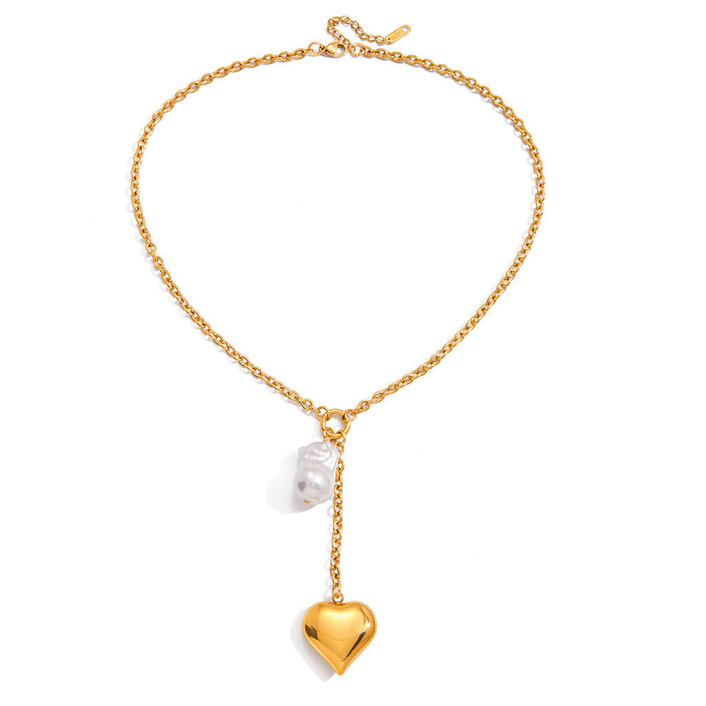 Full view of gold plated heart locket and white drop necklace