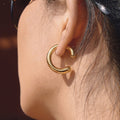 gold plated stainless steel open hoop earring worn on ear