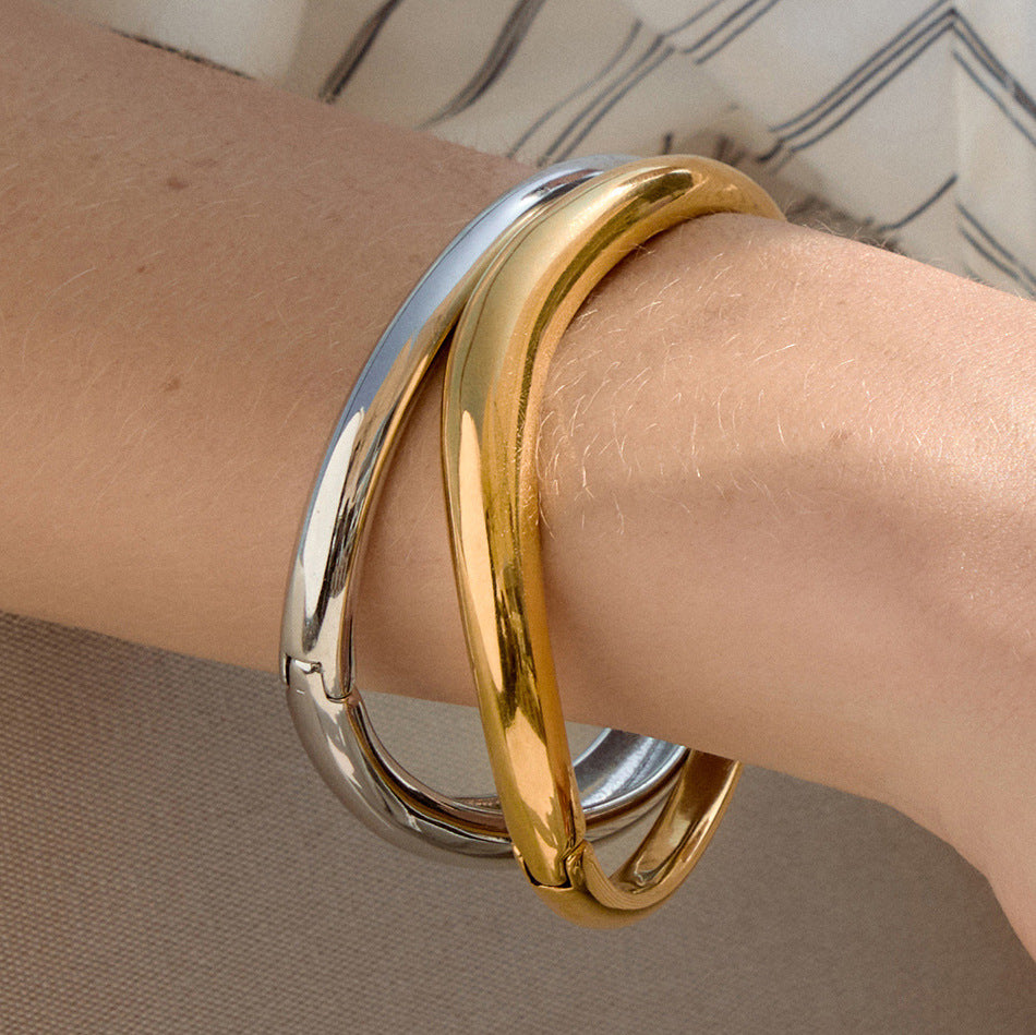 Close-up of smooth polished bangles on a wrist