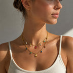 Multicolor layered necklace worn over a white top