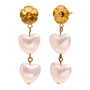 angled view of stainless steel flower and pearl heart earrings