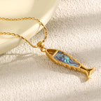 side view of iridescent abalone shell inside the fish pendant frame