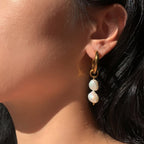 Side view of a double-pearl drop hoop earring
