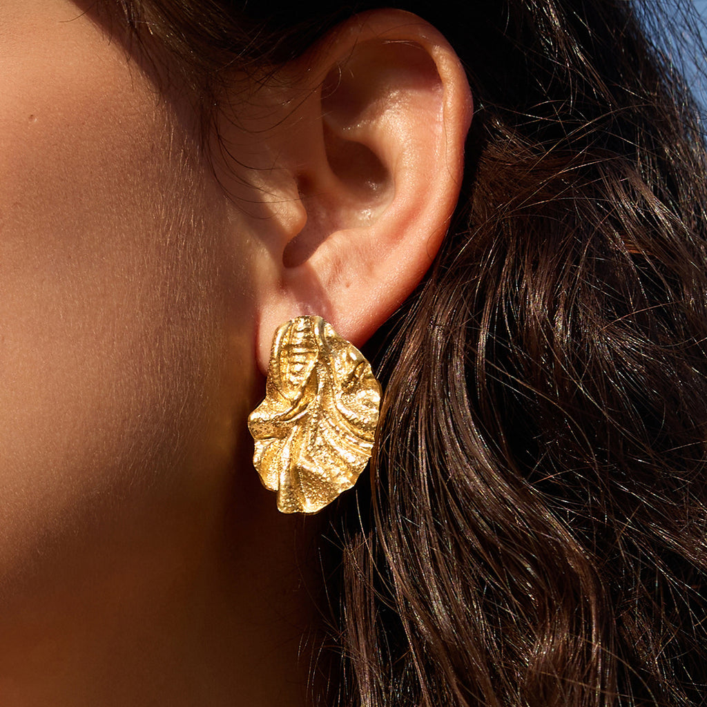 Sculpted fold stud earring worn close-up