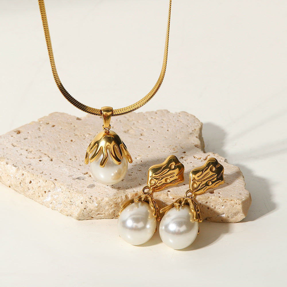 Capped white bead jewelry displayed against a pale stone block