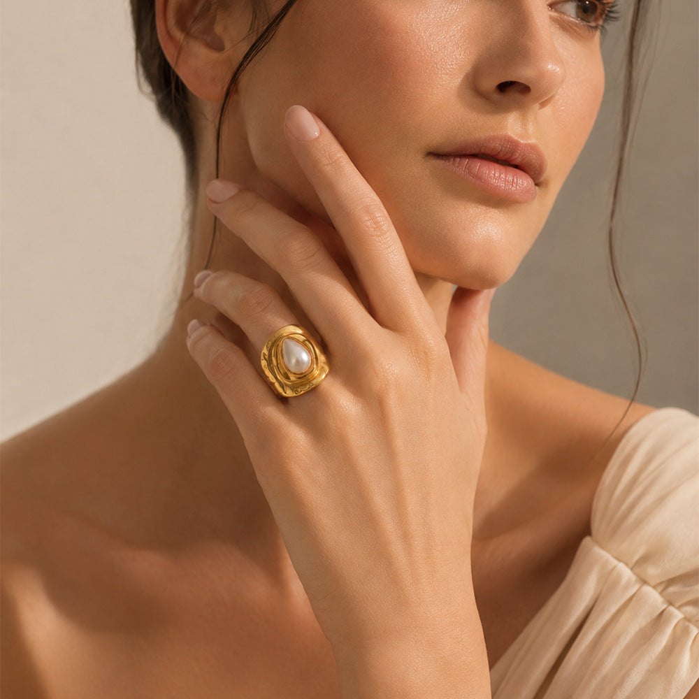 Gold plated white pearlescent ring worn on a model's hand