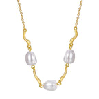 front detail of gray pearl and wave-link necklace