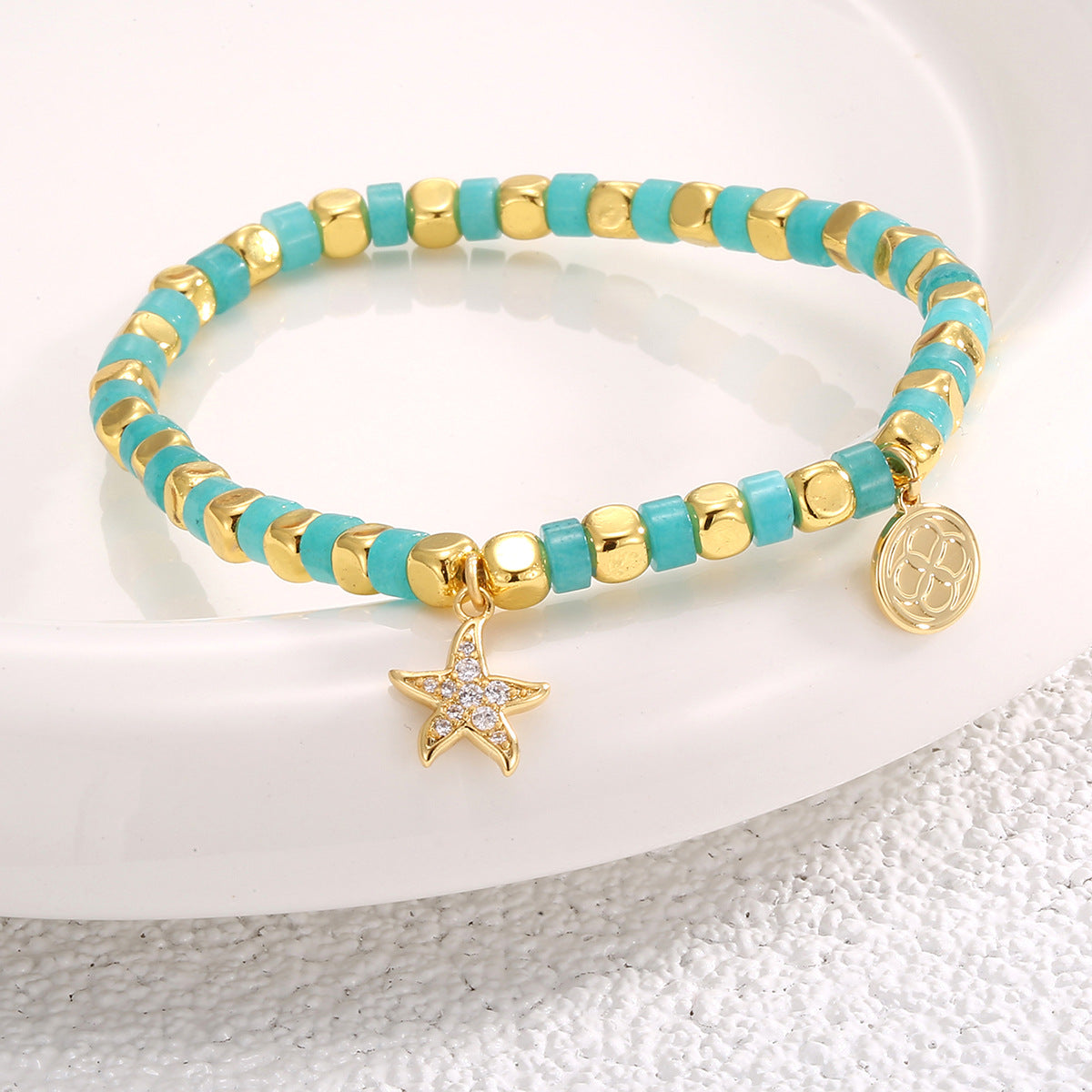 angled view of the gold plated starfish beaded bracelet