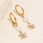 gold plated pearl flower drop huggie earrings at an angle