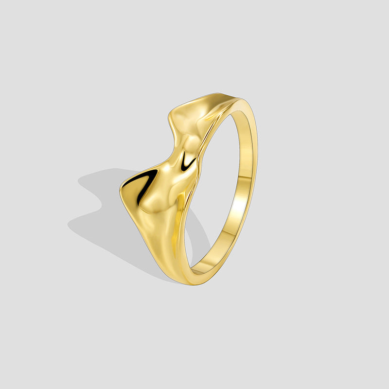 isolated gold plated brass sculptural molten wave ring