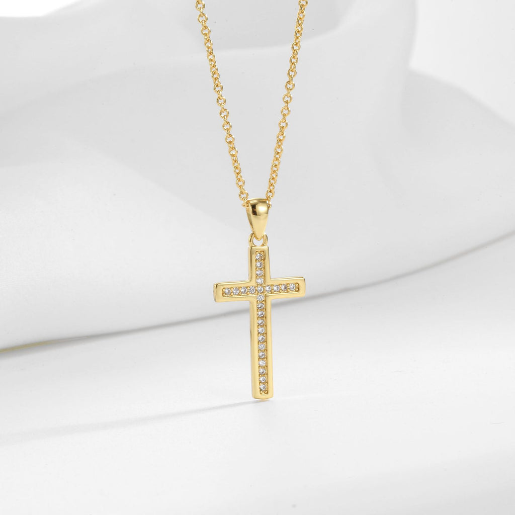cross pendant with narrow inset stone row on gold plated chain