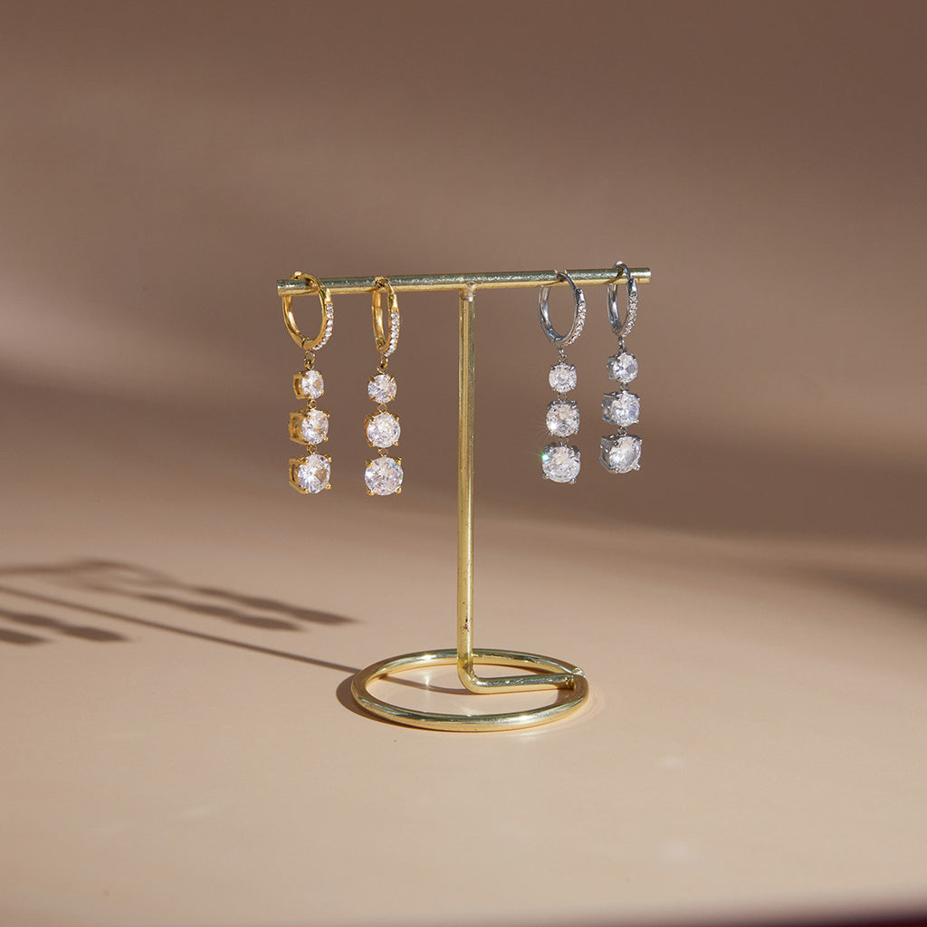 Gold-tone and silver-tone hoop drops on a stand