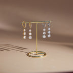 Gold-tone and silver-tone hoop drops on a stand