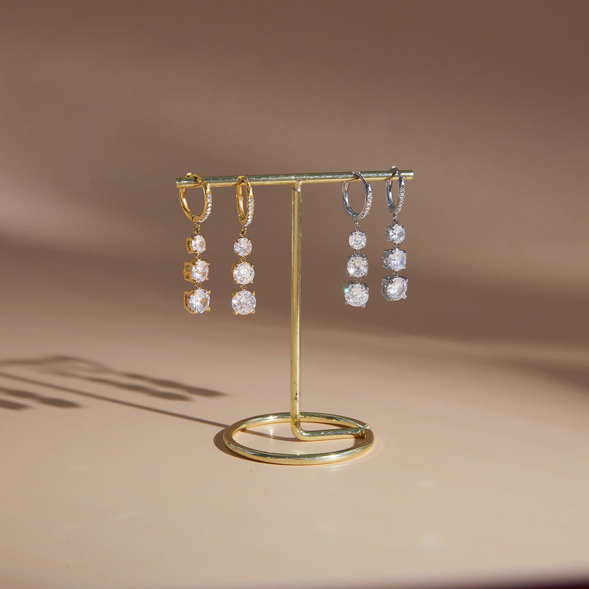 Gold-tone and silver-tone hoop drops on a stand