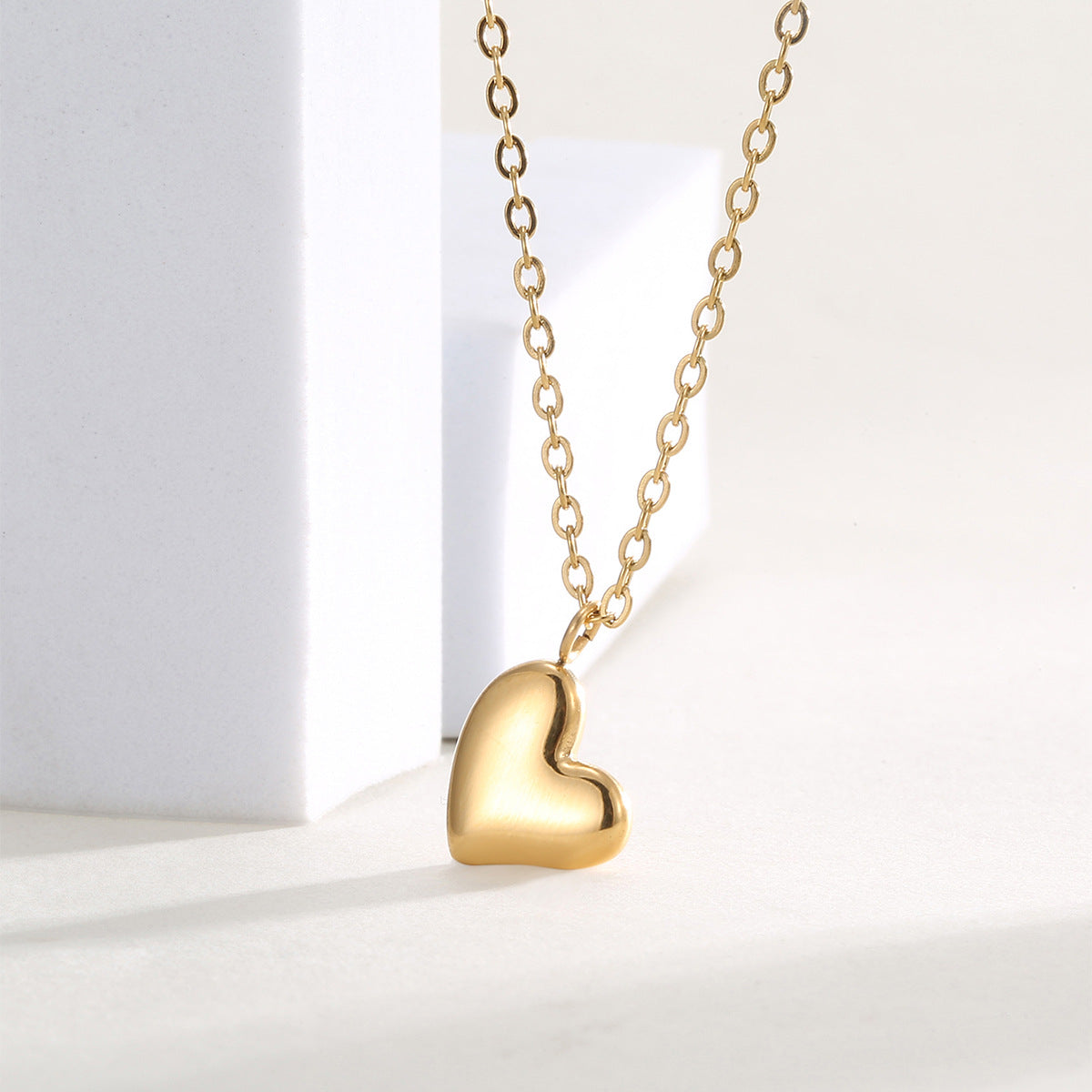 angled studio view of the smooth off-center heart pendant