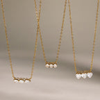 Triple-stone pendants hanging at different display heights