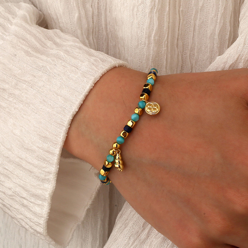 model wearing the gold plated coastal bead charm bracelet