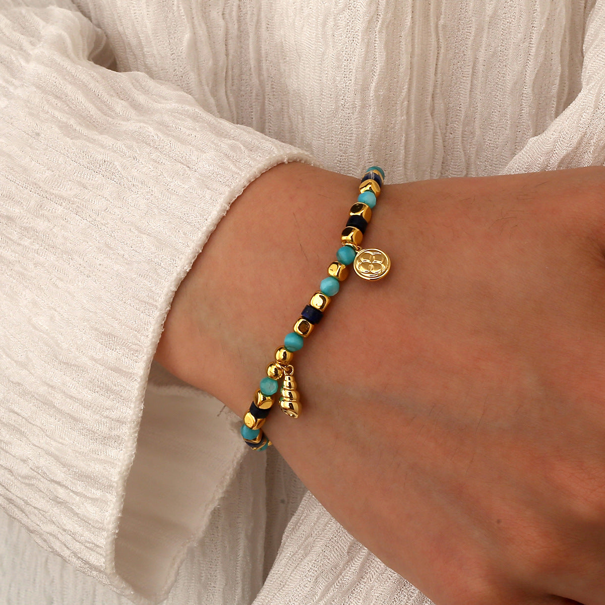 model wearing the gold plated coastal bead charm bracelet
