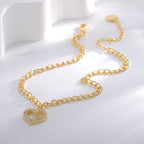 gold plated heart charm anklet laid in a soft curve