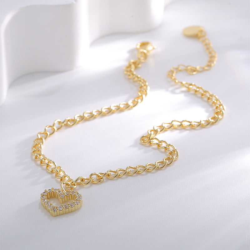 gold plated heart charm anklet laid in a soft curve