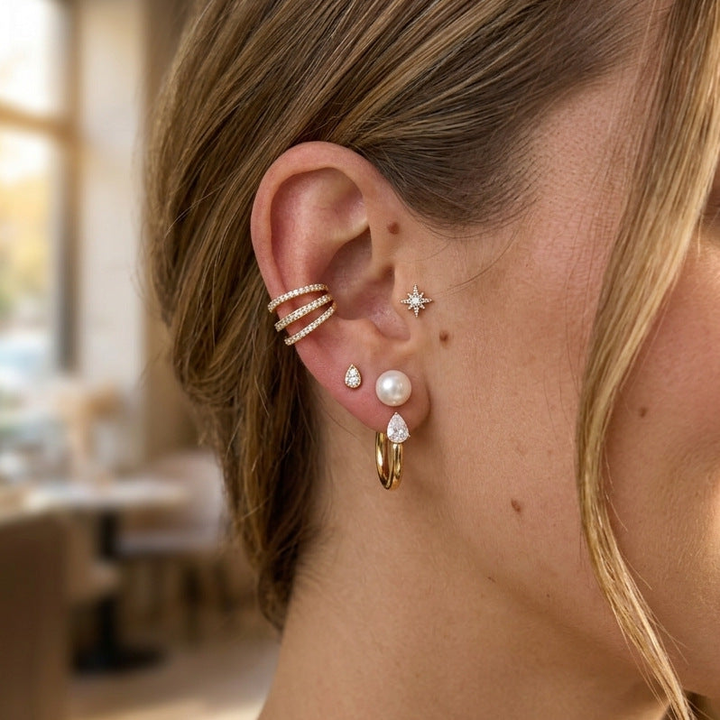 Gold tone pearl hoop shown on ear from another angle