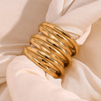 overlapping polished ring bands styled on cream satin