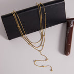 Layered fine chains displayed on a black accessory