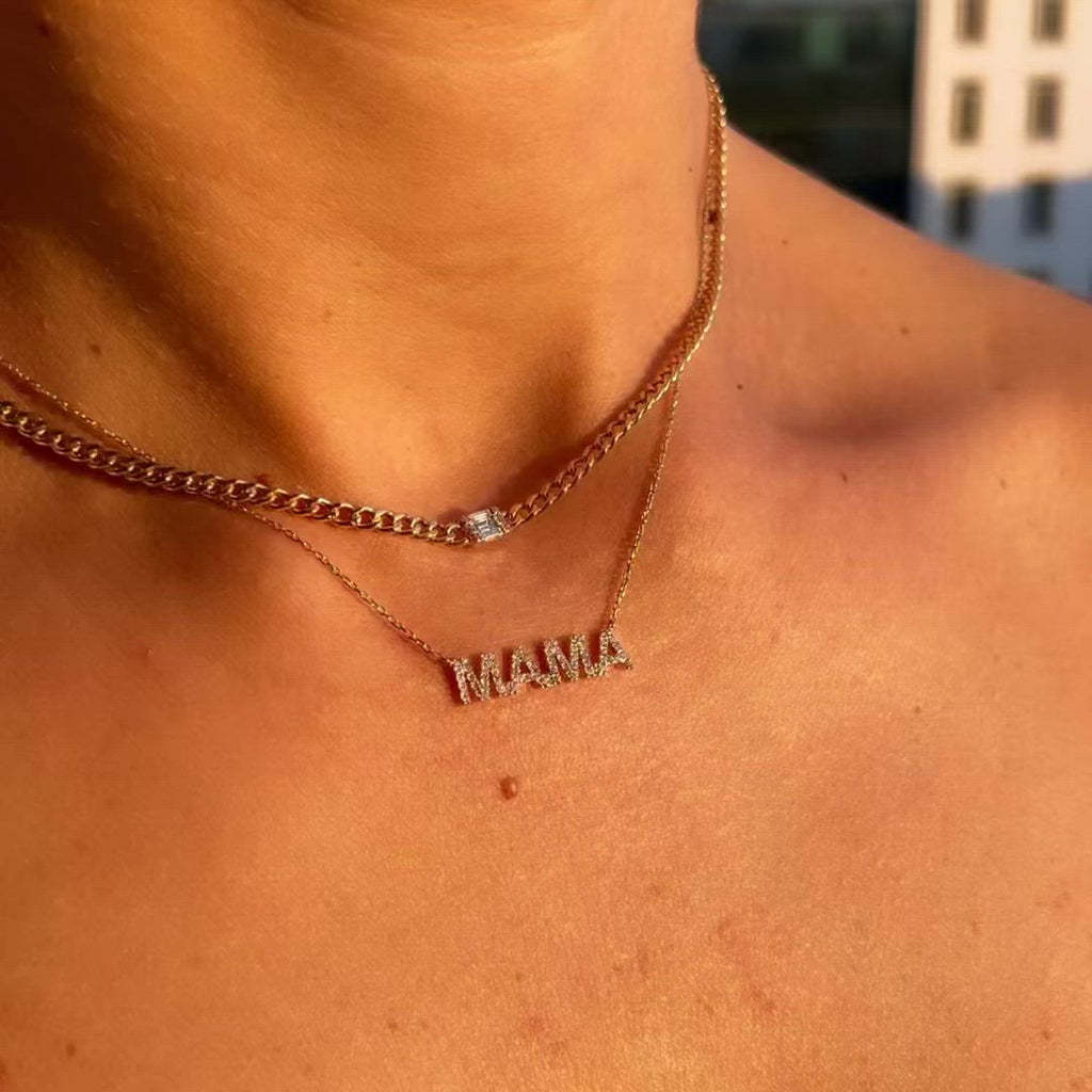 Fine gold-tone MAMA lettering necklace styled in sunlight