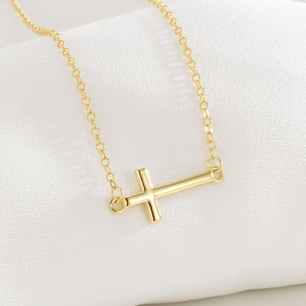 close view of polished cross integrated into fine cable chain