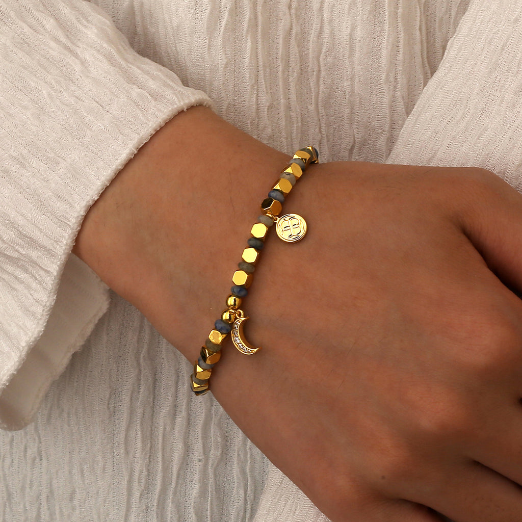 model wearing the gold plated blue dot quartz moon bracelet