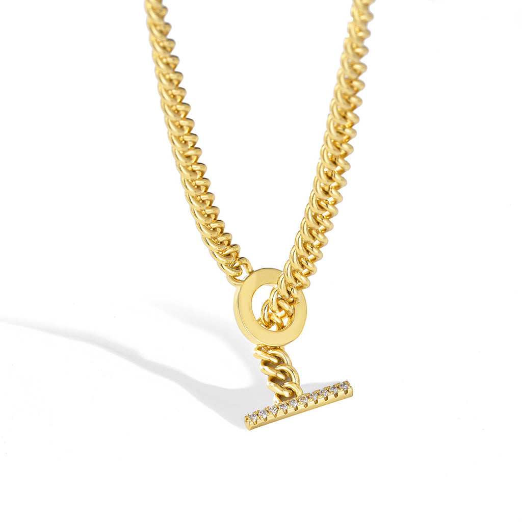 front view of gold plated toggle necklace casting a soft shadow