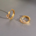 Gold tone hoops with oval stones set beside the bands