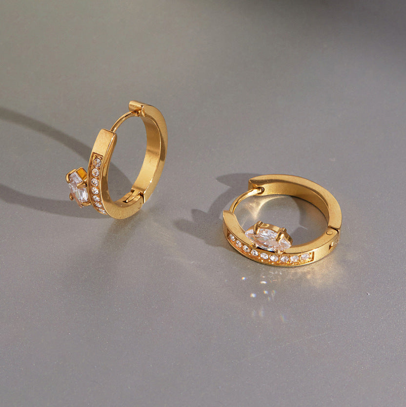 Gold tone hoops with oval stones set beside the bands