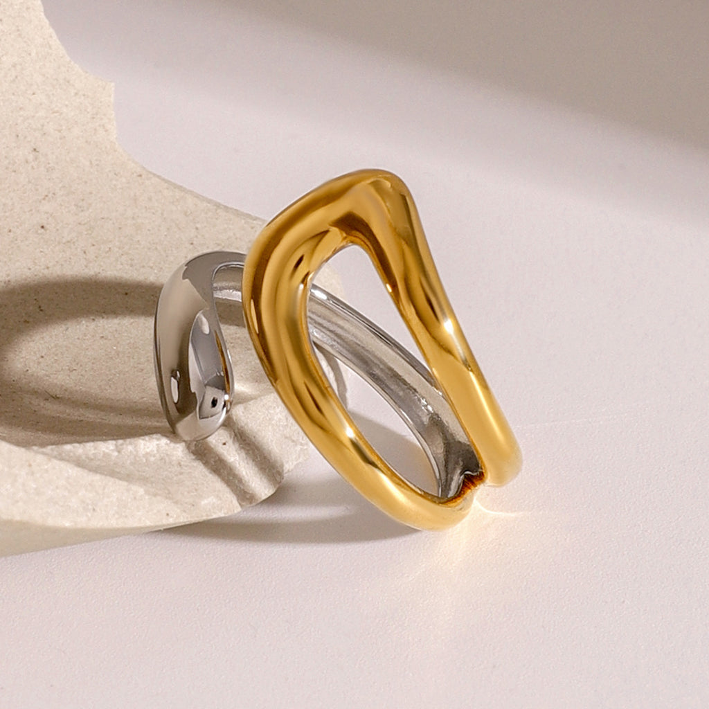Angled view of the gold plated open loop and silver-colored ring band