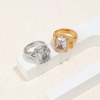 angled pair of rectangular clear-stone signet rings in two finishes