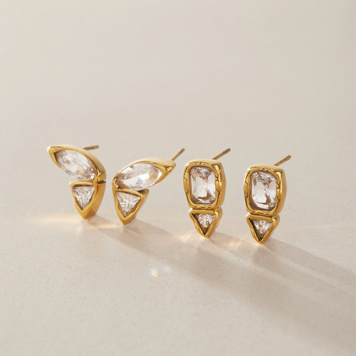 Two geometric zirconia stud designs displayed together