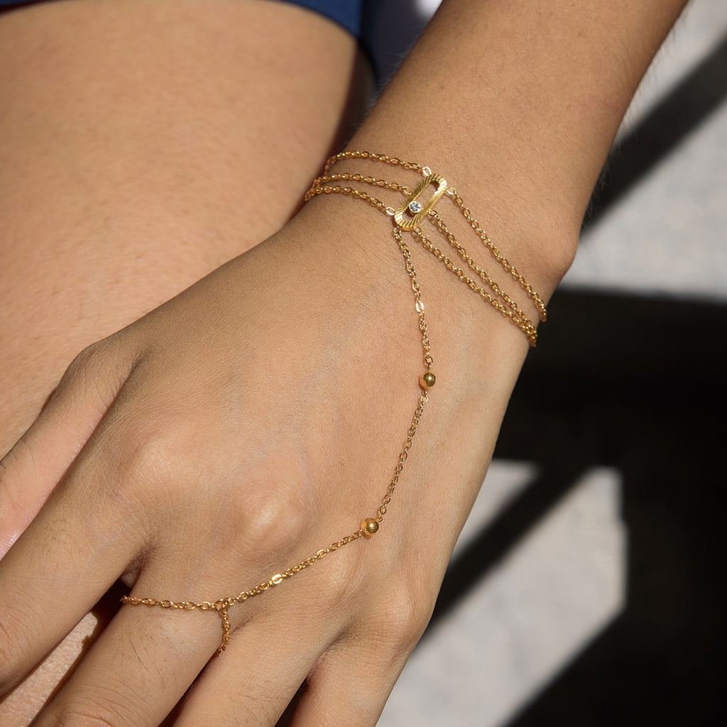 Layered hand chain bracelet worn with its finger loop