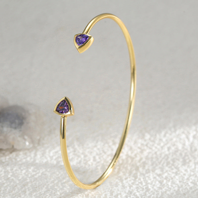 upright view of slim gold plated purple stone open cuff