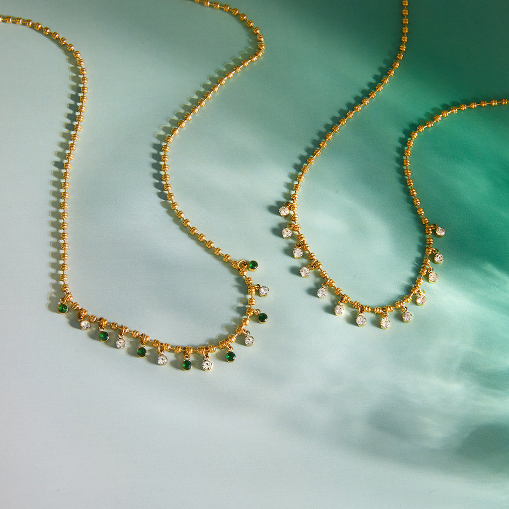 Clear and green drop details on necklace fronts