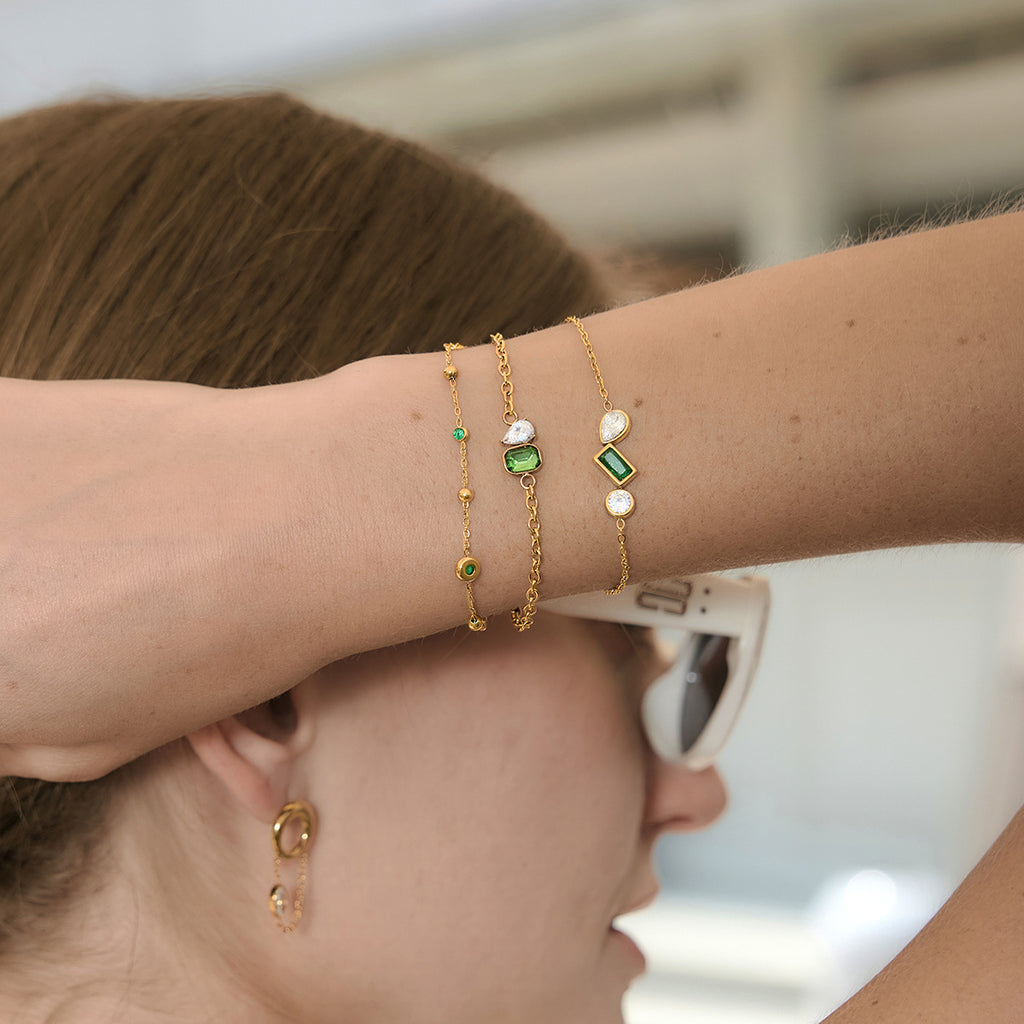 Three bracelet layers showing green accents