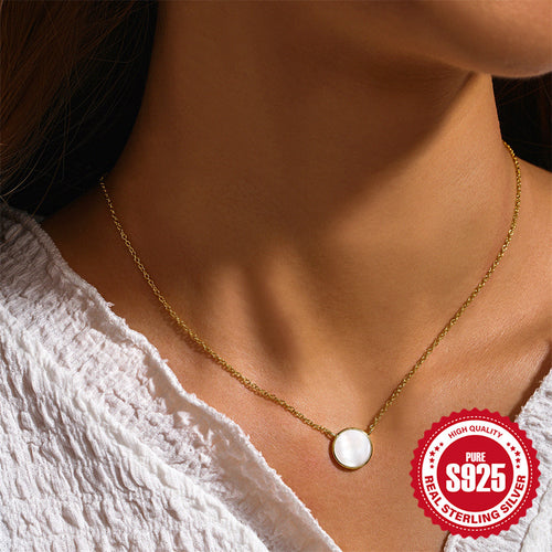 model wearing the gold plated round white shell pendant necklace