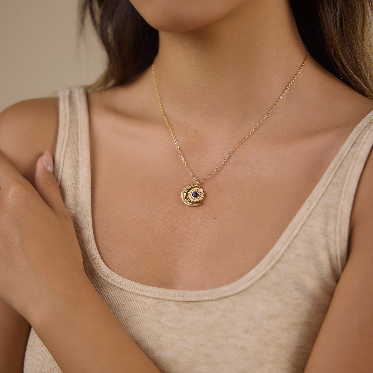 Gold tone celestial pendant necklace shown on model