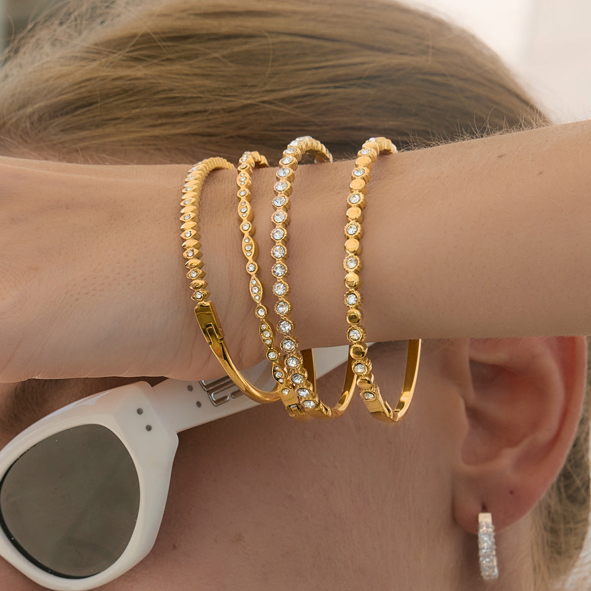 Gold-tone clear accent bangles styled as an arm stack