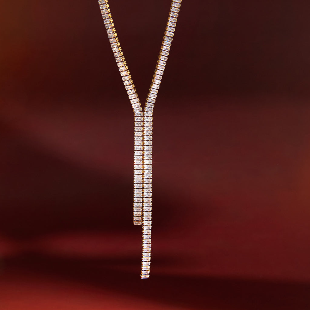 asymmetric double-drop clear-stone necklace in warm light