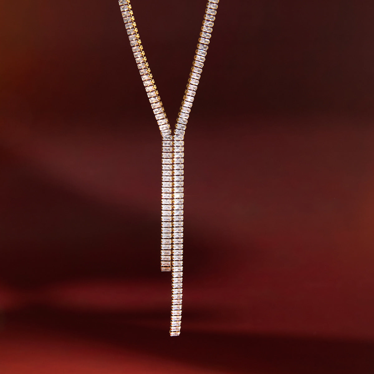 asymmetric double-drop clear-stone necklace in warm light