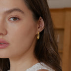 Polished spiral earrings worn with a white top